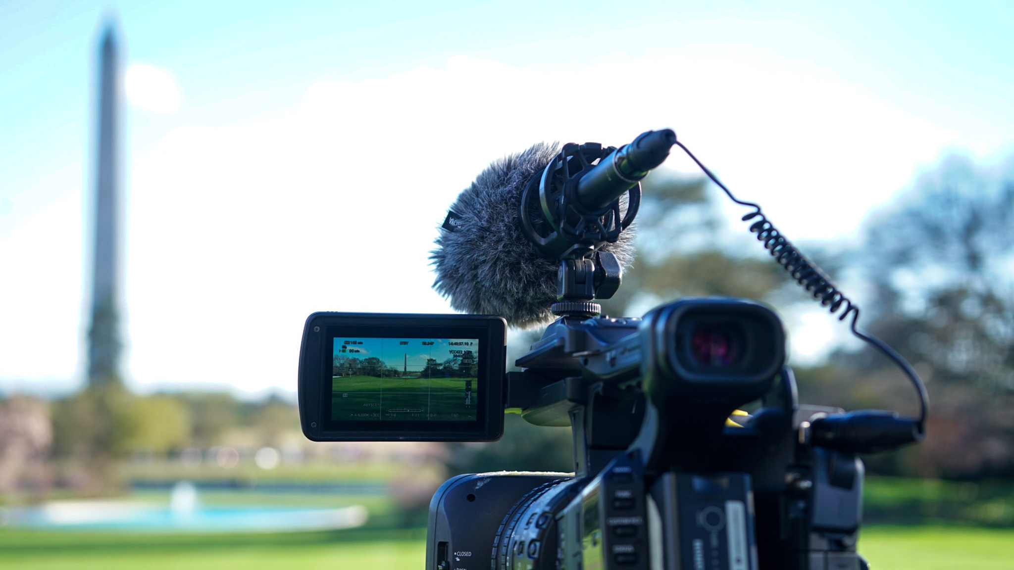 A news video camera filming near the Washington Monument